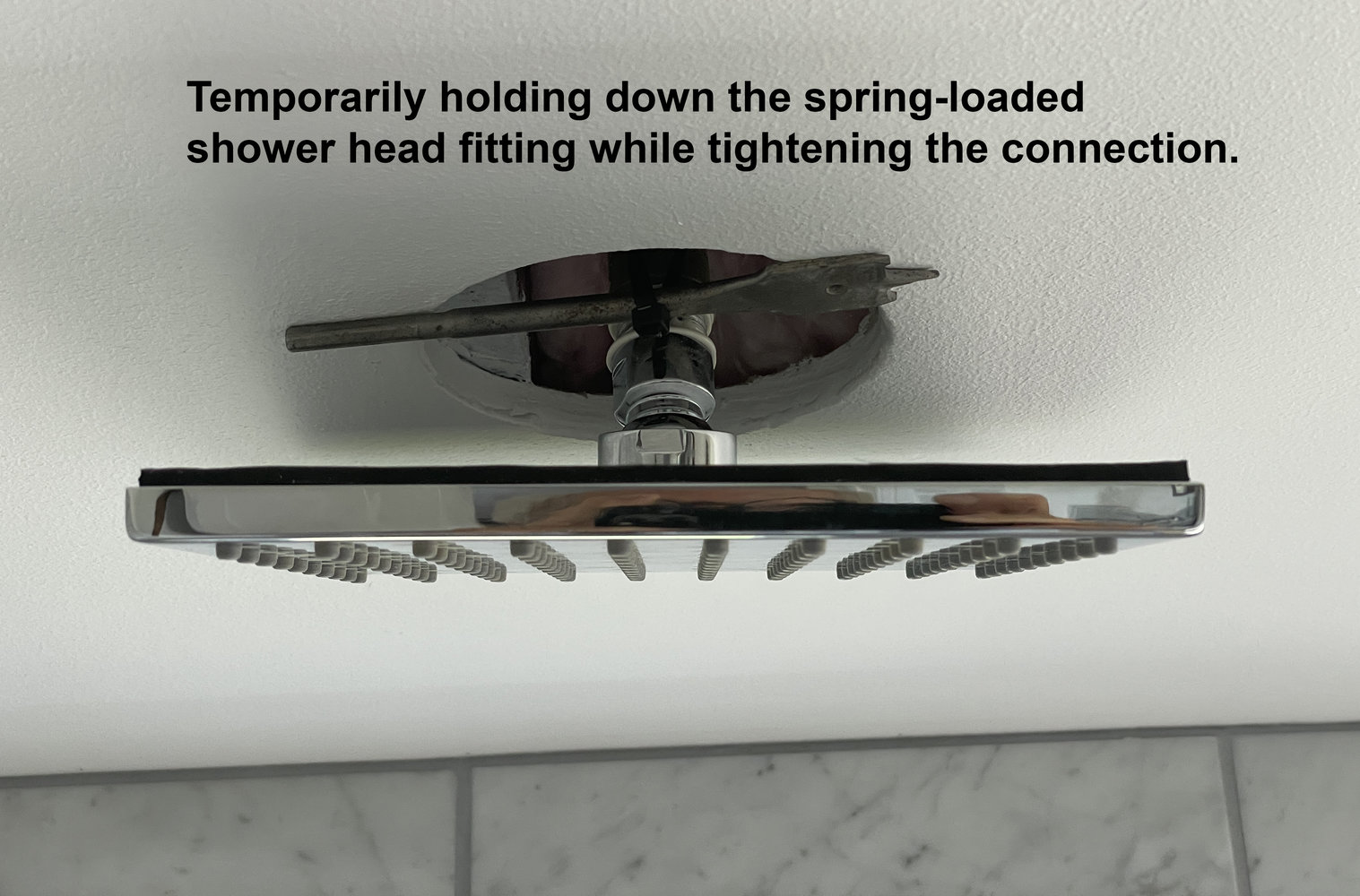 tightening-spring-loaded-shower-head-connection.jpg