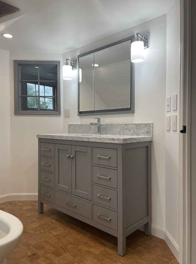 vanity-cabinet-with-marble-backsplash-1.jpg